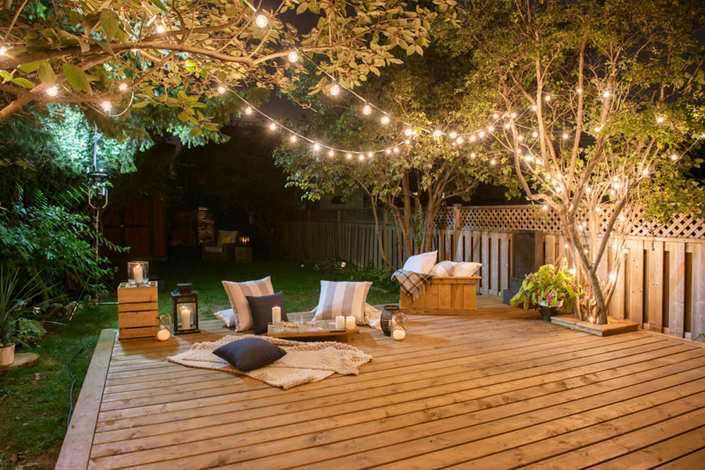 evening picture of a pressure treated lumber deck with lighting